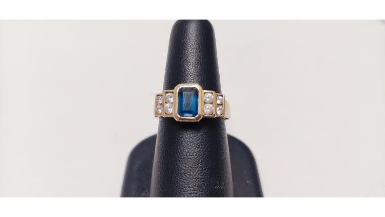 Anello con pietra blu centrale e bianche laterali.