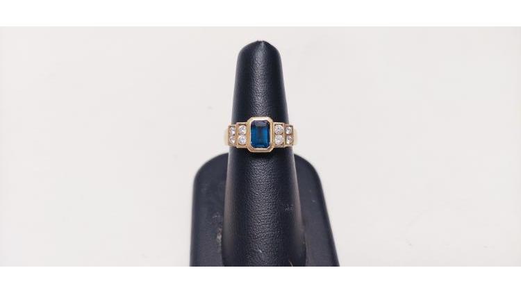 Anello con pietra blu centrale e bianche laterali.